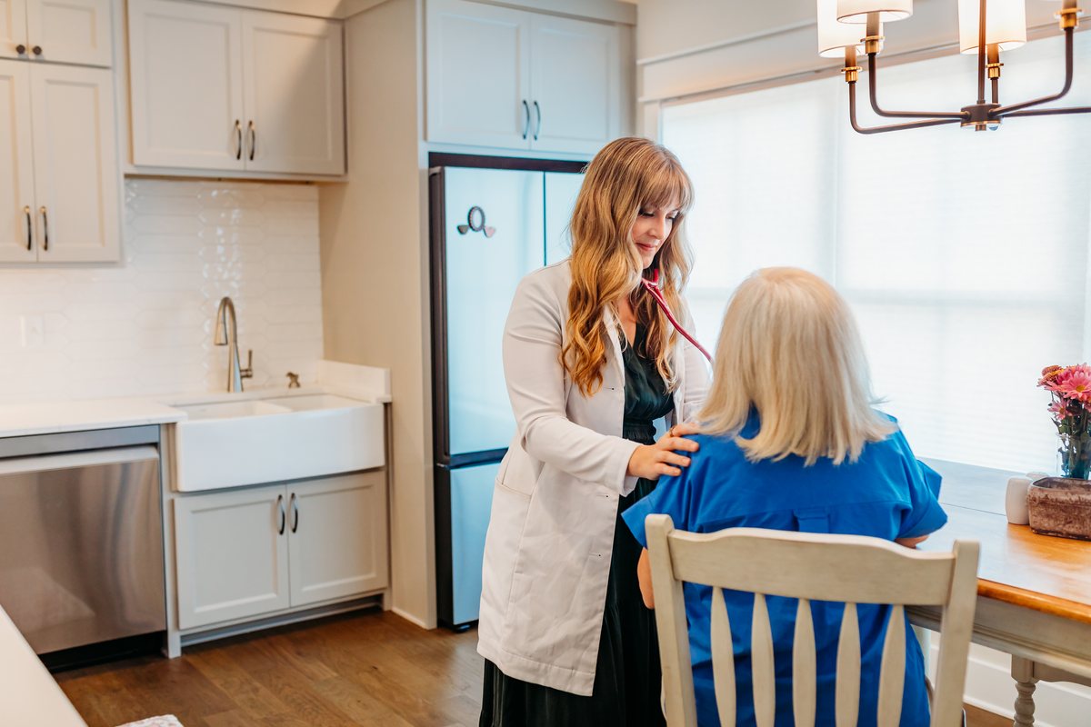 Dr. Joella Lambert listening to a patient during a house call